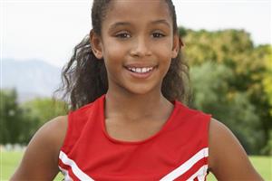 A youth cheerleader smiling