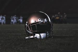 A football helmet sitting on field
