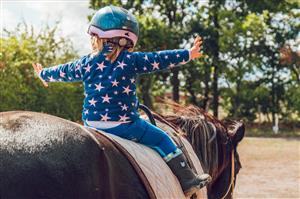 Young girl riding horse